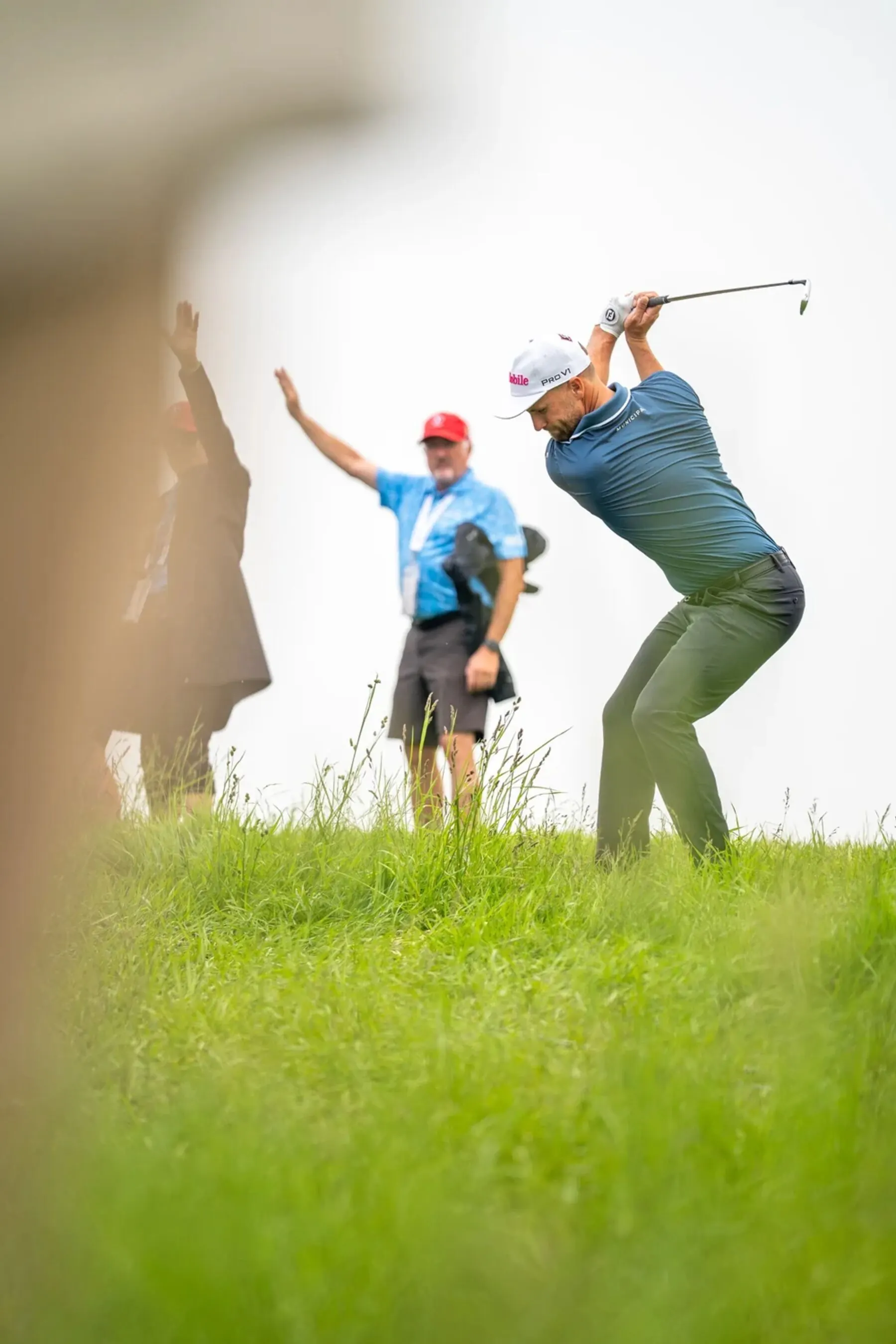 Golfer swinging from the rough at the RBC Canadian Open