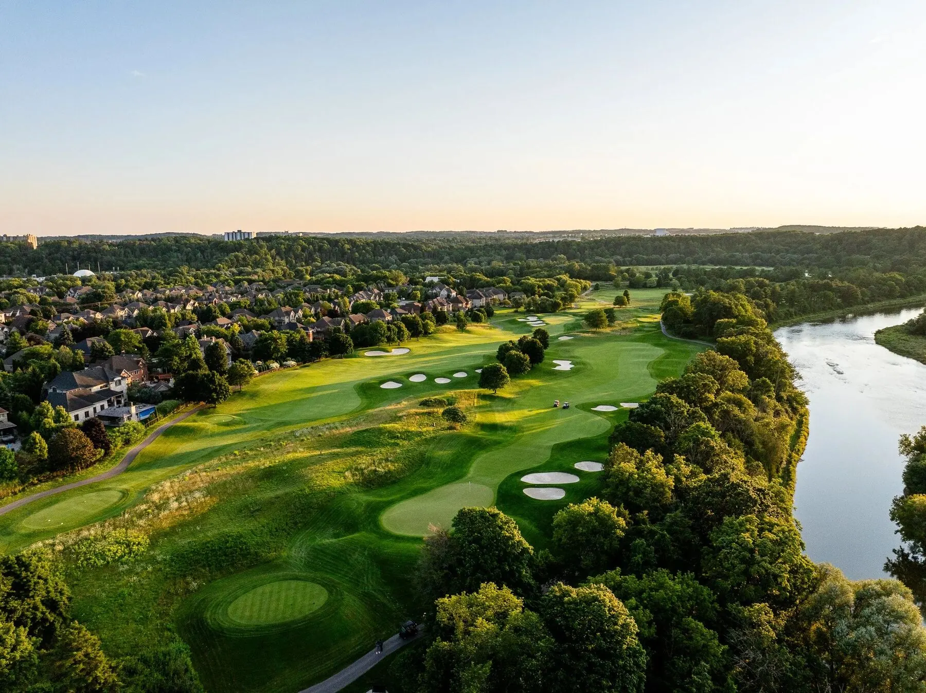 Aerial view of Deer Ridge along the river with the community beyond