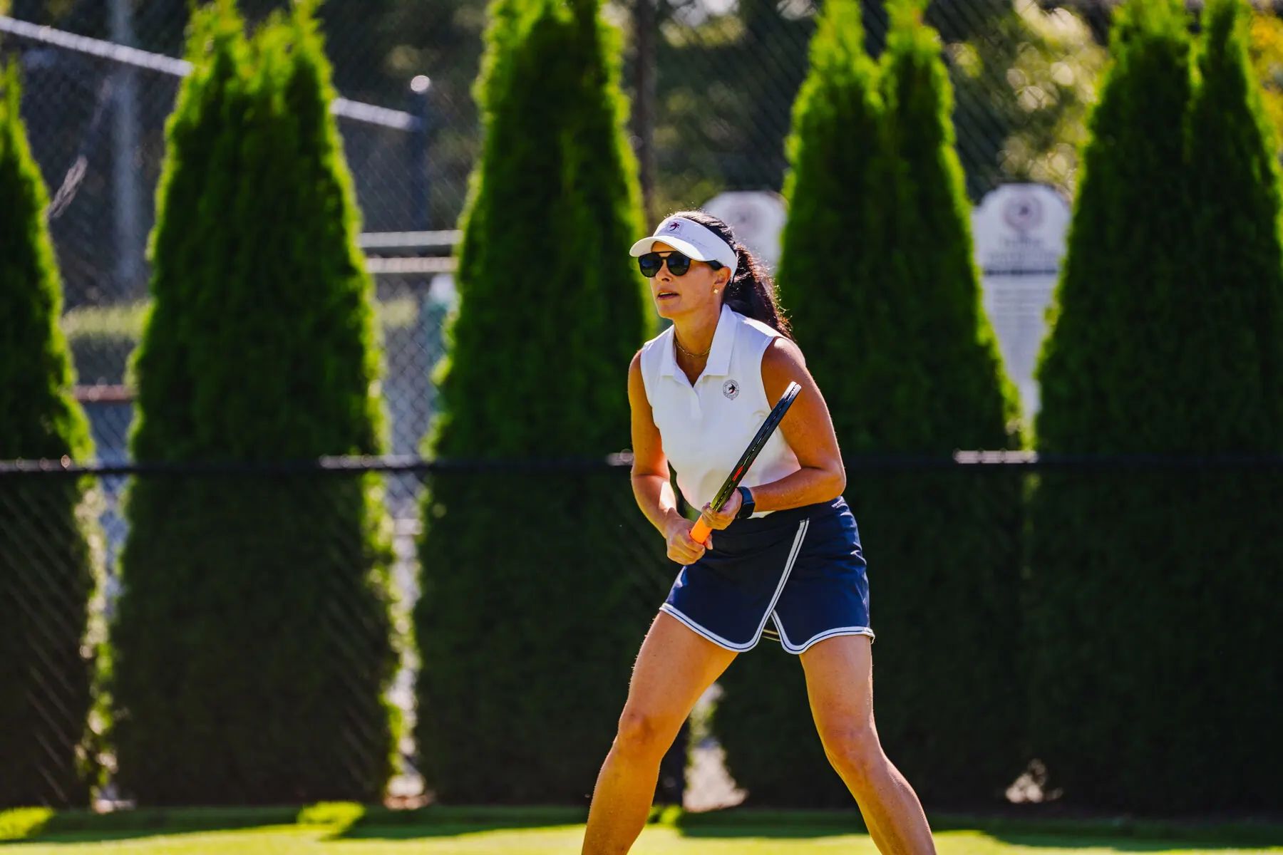 Tennis player on the grass court at Huntington Crescent Club
