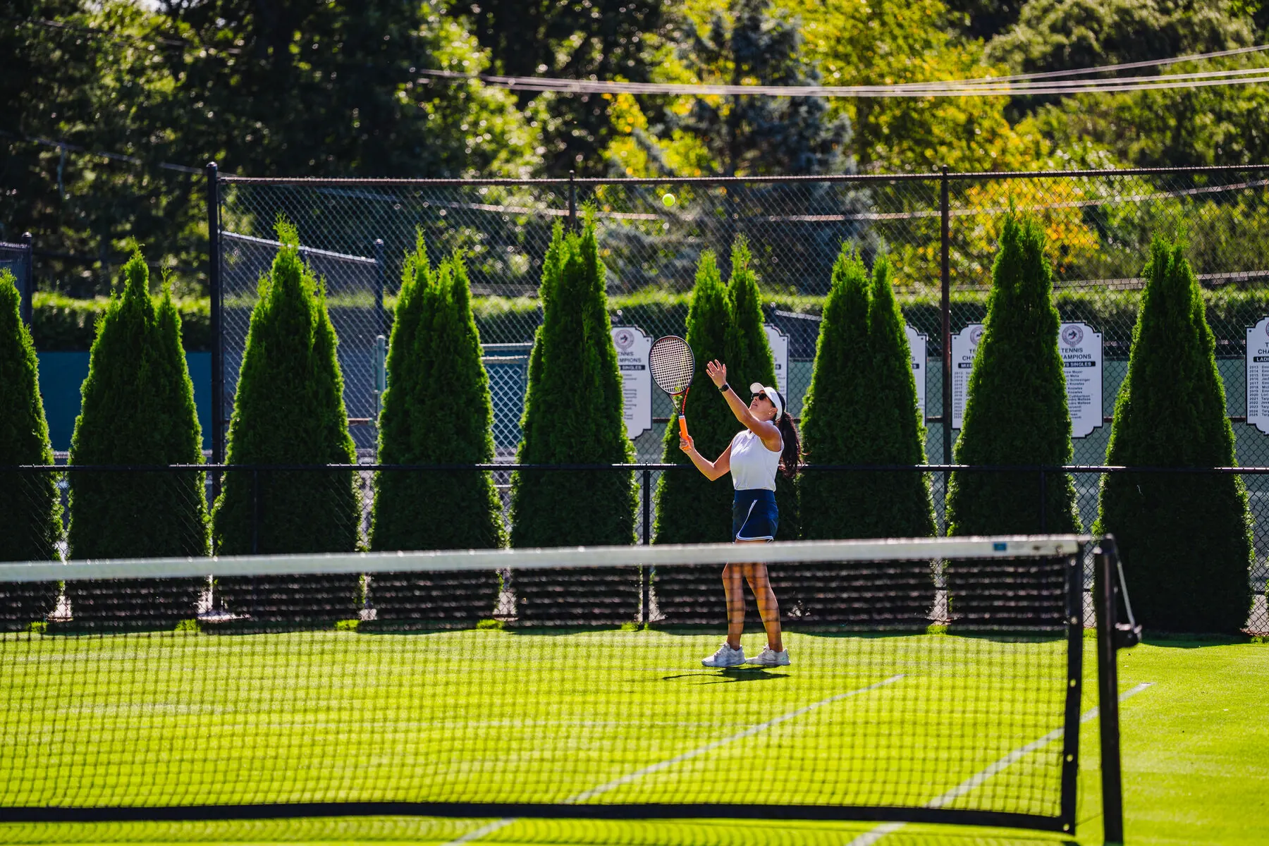 Tennis players on the grass court at Huntington Crescent Club