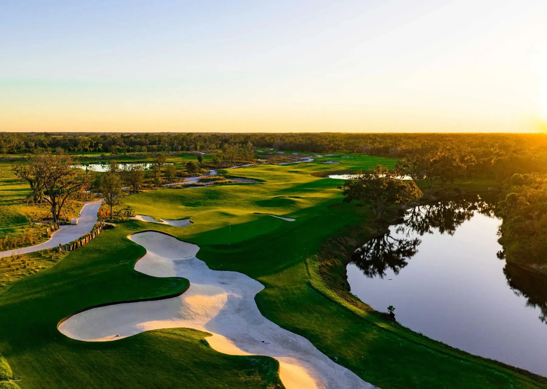 Miakka Golf Club green at sunset with water