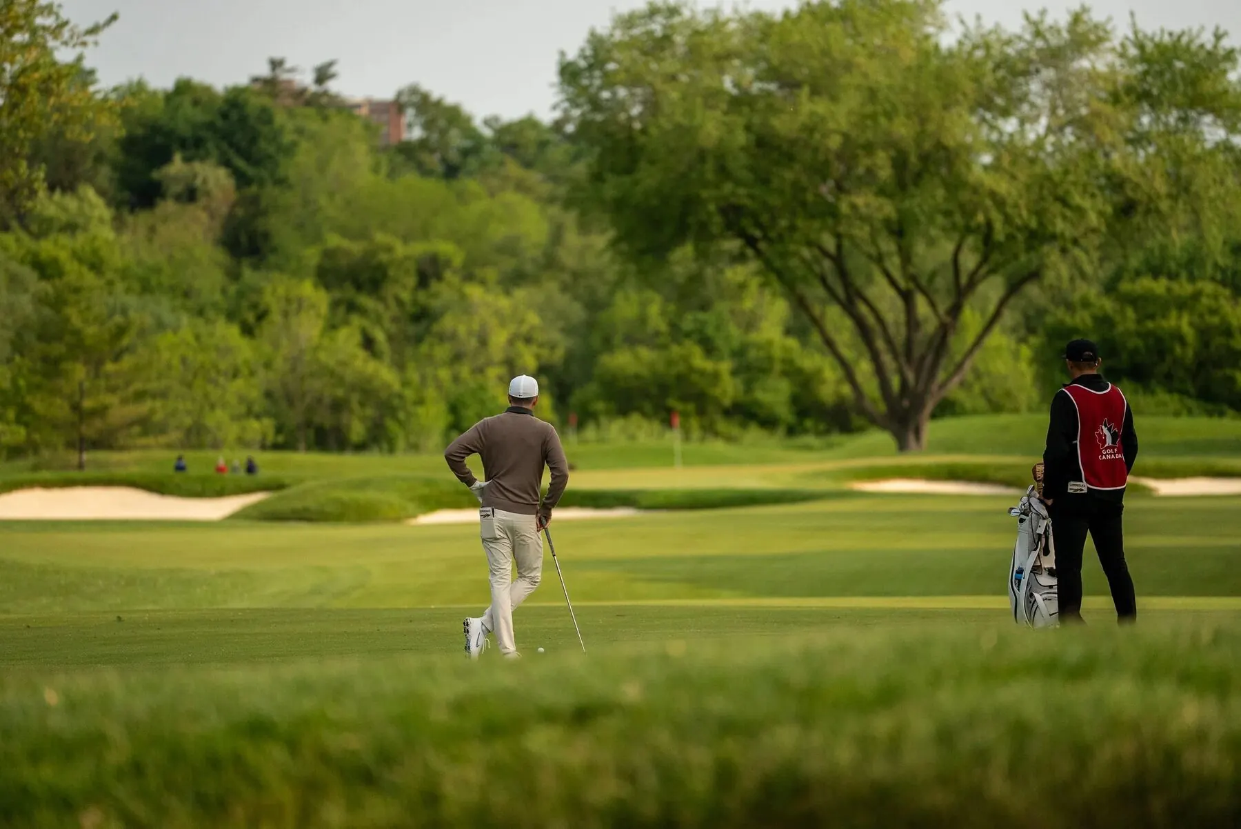 Player and caddie walking the green